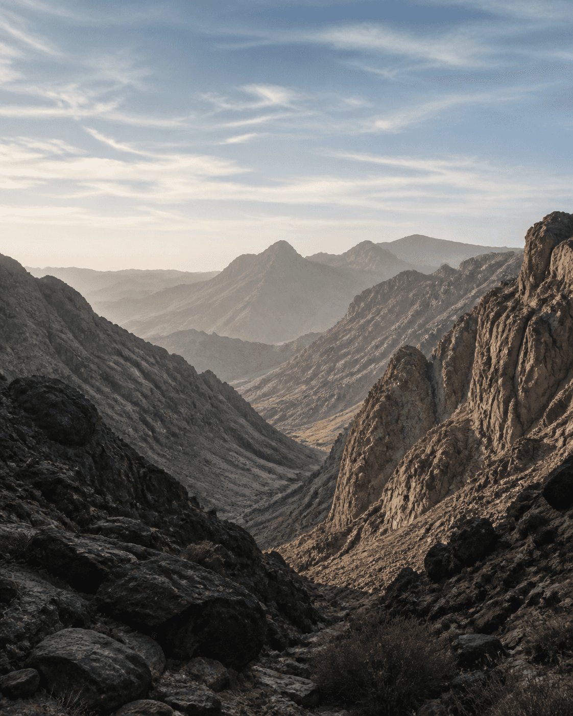 A dramatic mountain valley above a quiet alpine lake